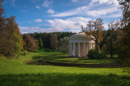 Temple of Friendship on the bank of the Slavyanka River in the Pavlovsky Palace and Park Complex on an autumn sunny morning, St. Petersburg, Russia