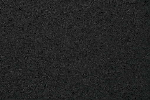 black paper background with blank space. dark texture as wallpaper