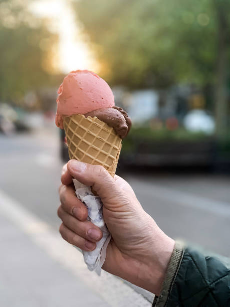 istock Male hand holding cone ice cream 1397237406