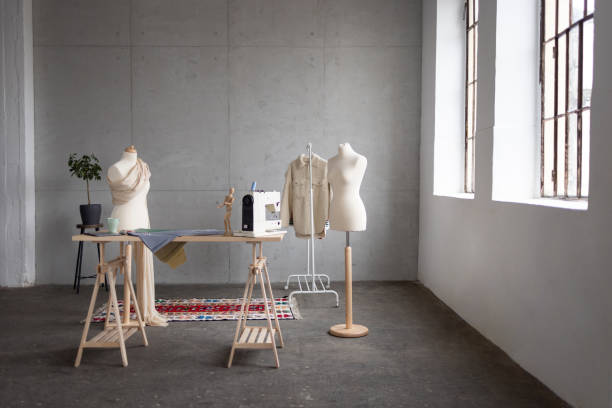 Wide angle view of an empty fashion studio Wide angle view of an empty fashion studio with no people in it, a mannequin and some clothes design studio stock pictures, royalty-free photos & images