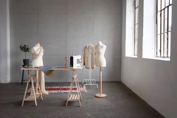 Wide angle view of an empty fashion studio with no people in it, a mannequin and some clothes