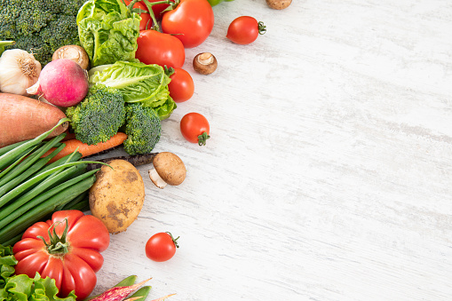 Fresh and raw vegetables on white wooden table with copy space