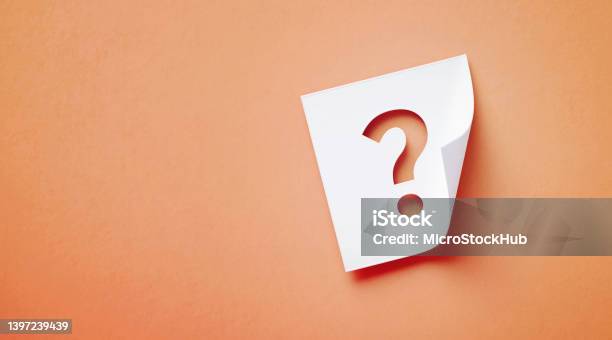 White Adhesive Note With Cutout Question Mark Sitting Over Orange Background Stock Photo - Download Image Now
