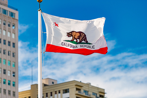 Flag of California Republic in San Francisco. Blue sky with clouds in background.