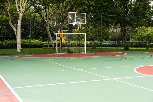 View of a sports court with beams and table with basket inside a park. Widely used for football, basketball and volleyball.