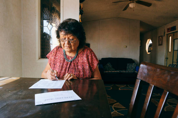 istock Woman Voting With a Mail In Election Ballot 1397246949