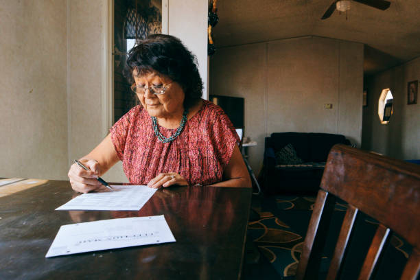 istock Woman Voting With a Mail In Election Ballot 1397246954