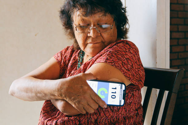 Senior Woman Checking Blood Glucose Level on an App stock photo