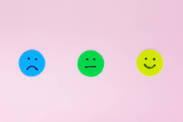 istock Three different emojis sad, happy and neutral face on a pink background 1397249406