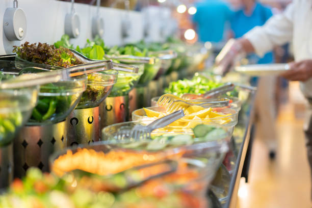 istock People in a salad buffet line with full plates 1397251400