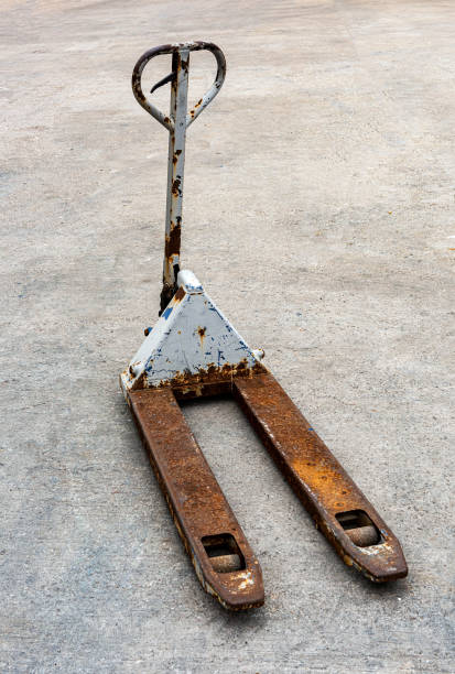 Shipping merchandise retail manual pallet jack on concrete floor Shipping merchandise retail manual pallet jack on concrete floor. pallet jack handle stock pictures, royalty-free photos & images