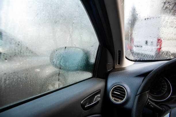 steamy car windows on a autumn rainy/foggy day. concept of safety driving problem - wet dew drop steam imagens e fotografias de stock