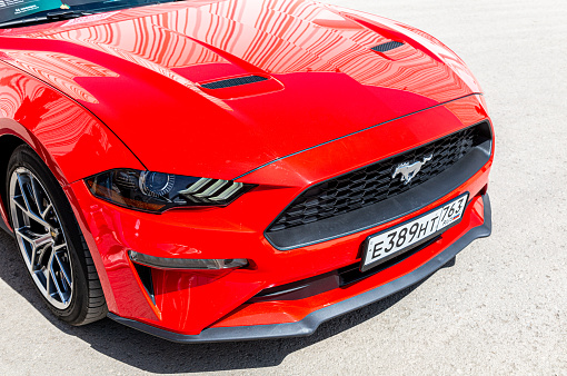 Samara, Russia - May 8, 2022: Front part of Ford Mustang vehicle with car grille and licence plate. Ford brand is a manufacturer of cars in USA