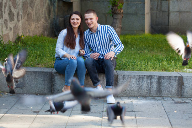 istock Young couple feeding pigeons 1397255516