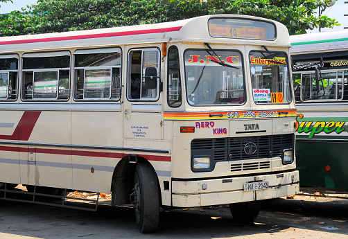 Old retro bus converted for recreational use travelling on a four lane highway.