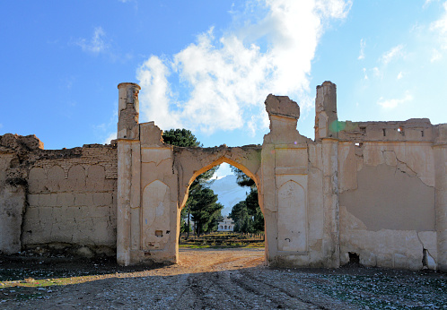 Kholm / Khulm / Tashqurghan, Balkh province, Afghanistan: battered arch, missing gates, of the Bagh-e Jahan Nama Palace compound, built in the Indian colonial style in the late 19th century by Amir Abdur Rahman Khan, know as the 'Iron Emir', Barakzai dynasty.