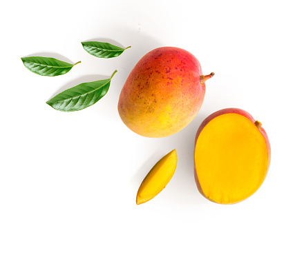 Creative layout made of mango and leaves. Flat lay. Food concept. Mango on white background.
