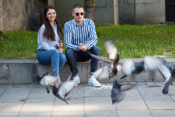 istock Young couple feeding pigeons 1397258095