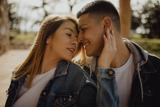 istock Beautiful young couple expressing their feelings outside 1397259264