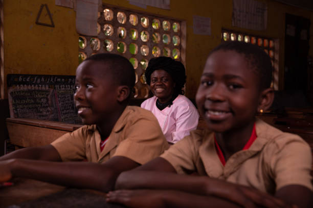 istock African teacher sitting in the classroom with her pupils 1397260009