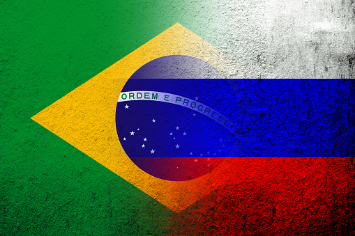 National flag of Russian Federation with National flag of Brazil. Grunge background