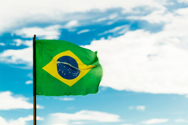 istock Brazil flag with blue sky in the background. 1397266320