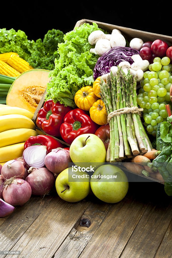 Rustic crate full of fruits and vegetables Fruits and Vegetables Basket on Wood Table Backgrounds Stock Photo