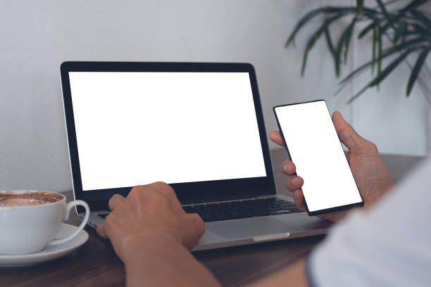 istock Mockup of man using smartphone and laptop in cafe 1397270134