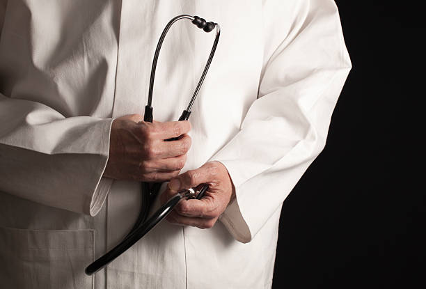 Doctor with black stethoscope stock photo