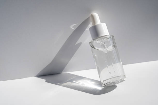 istock A white transparent bottle with serum in the rays of the sun. 1397271003