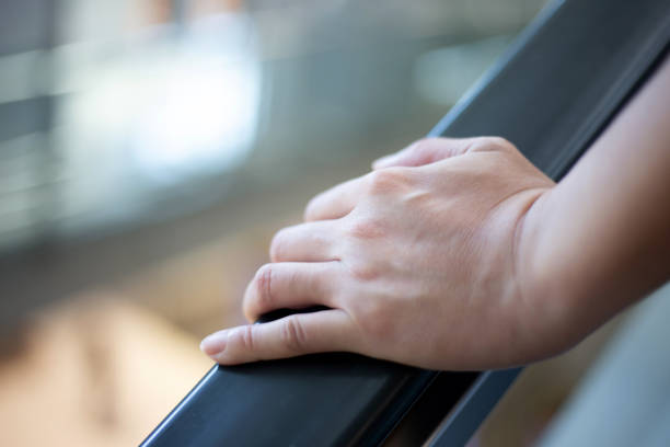 istock Person holding handrail of escalator 1397273441