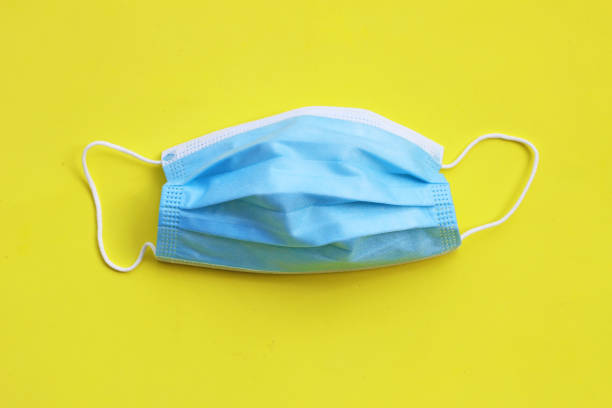 istock Medical protective mask on yellow background. 1397274245