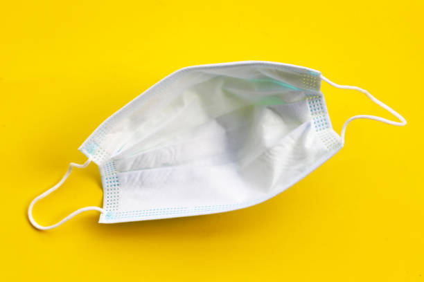 istock Medical protective mask on yellow background. 1397274254