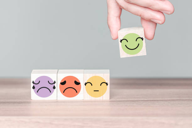 istock Hand holding a wooden cube block with happy smile face icon, good feedback rating customer review, customer service evaluation concept. 1397275420