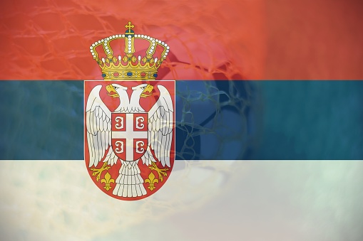 Serbia flag with Soccer ball in goal as background, sport and success business concept.