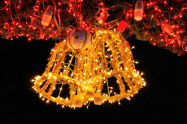 Golden jingle bell on Christmas tree