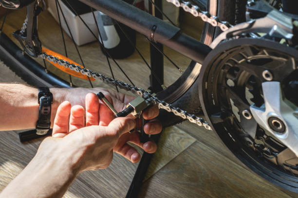 istock Mechanic replacing a bicycle chain with a special tool 1397281692