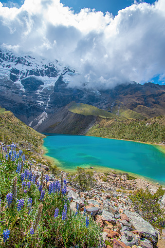 Humantay Lake,  Cusco, Peru - May 9, 2022;  The Humantay Lake  is located about 75 miles to the northwest of Cusco and just south of Machu Picchu. The lake can be found between Humantay Mountain and Salkantay Mountain.  Humantay Lake is most well known for its bright blue water. This colour comes from the mineral-filled runoff from the melting glaciers around the Humantay and Salkantay Mountains.
