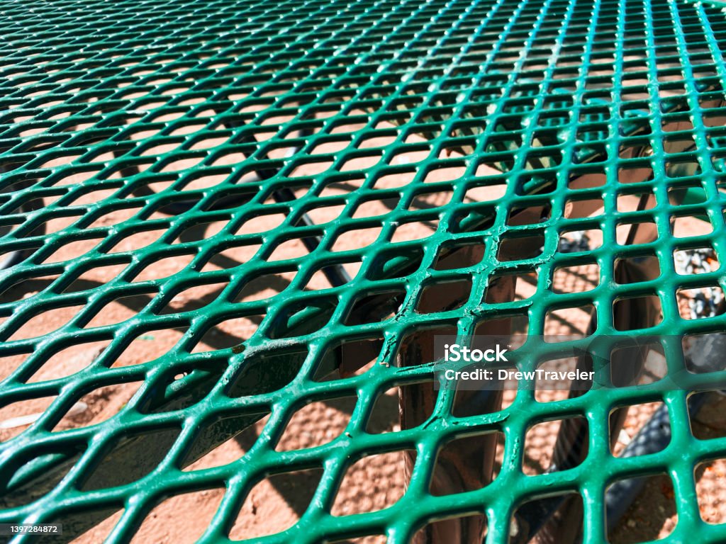 picnic table green park plastic coated mesh protective party park perforated eating community play closeup a picnic table green park plastic coated mesh protective party park perforated eating community play closeup Coating - Outer Layer Stock Photo