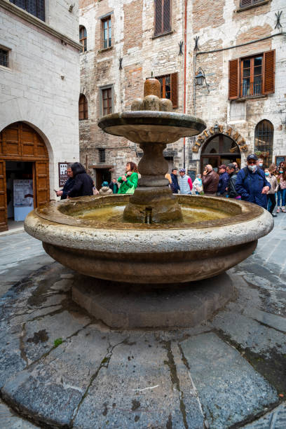 Gubbio, Italy - April 25, 2022: the medieval fountain of the Bargello, in the historic center of Gubbio (Umbria region, central Italy). Also known as \