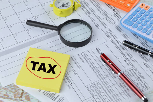 istock Selective focus of office tools and memo note with word TAX 1397288592