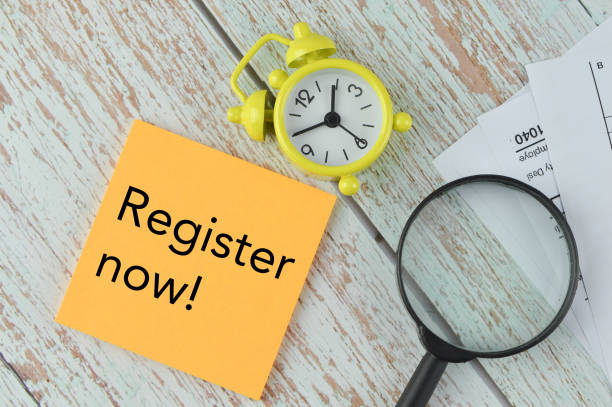 istock Top view of clock, magnifying glass and memo note written with REGISTER NOW! 1397288785