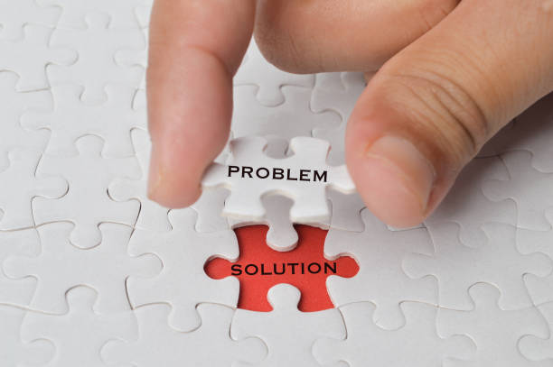 istock Management concept with hand holding piece of jigsaw puzzle with PROBLEM and SOLUTION wording. 1397288937