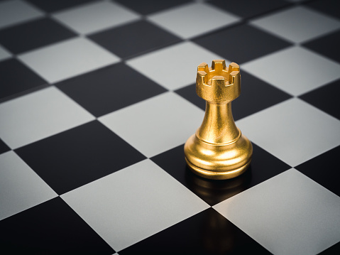 Chess white pawn and black defeated king on black background