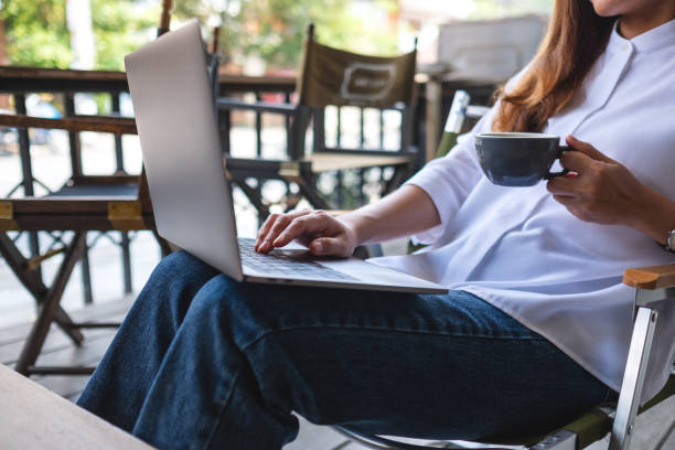 istock Closeup image of a young woman working and typing on laptop computer while drinking coffee 1397294730