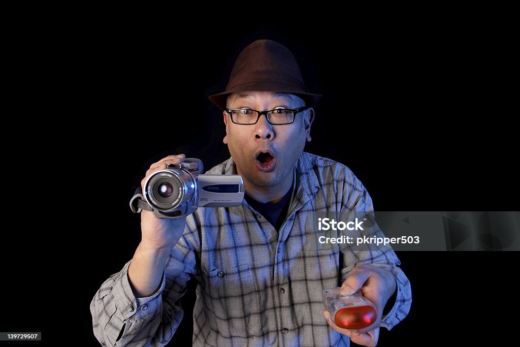 Ghost hunter Ghost hunter with a video camcorder and EMF detector. Adult Stock Photo