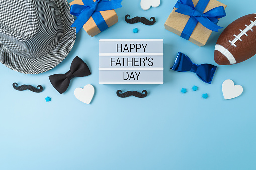 Happy Father's day greeting background with lightbox, hat, gift box and decorations. Flat lay, top view