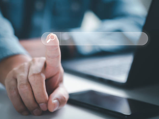istock Search Engine, search information on internet online. Man hand clicking search bar finding information or data on internet, website online. Concept of SEO, Cell phone, Smartphone, Technology, Computer 1397300671