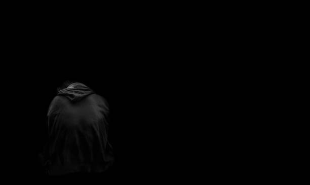 istock depressed man sitting in the dark 1397301495
