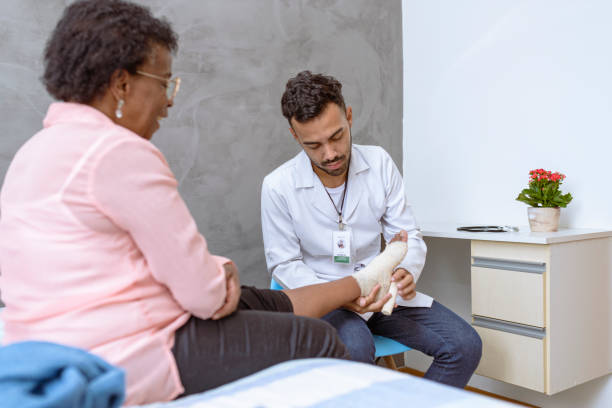 istock Nurse bandaging foot due to bruise 1397302200